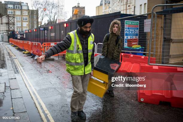 Building subcontractors, working for MJ Hillson Ltd., remove tools from the Barts Square development, operated by Carillion Plc, in London, U.K., on...