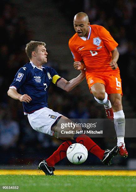 Darren Fletcher of Scotland tackles Demy de Zeeuw of Netherlands during the FIFA 2010 World Cup Group 9 Qualifier match beteween Scotland and...