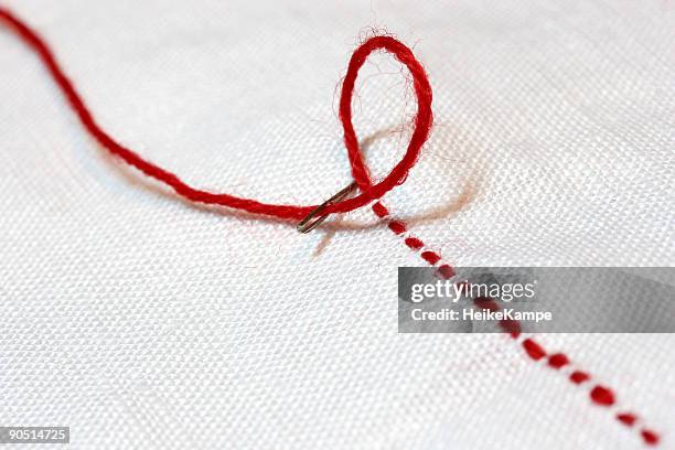 the red thread - embroidery stock pictures, royalty-free photos & images