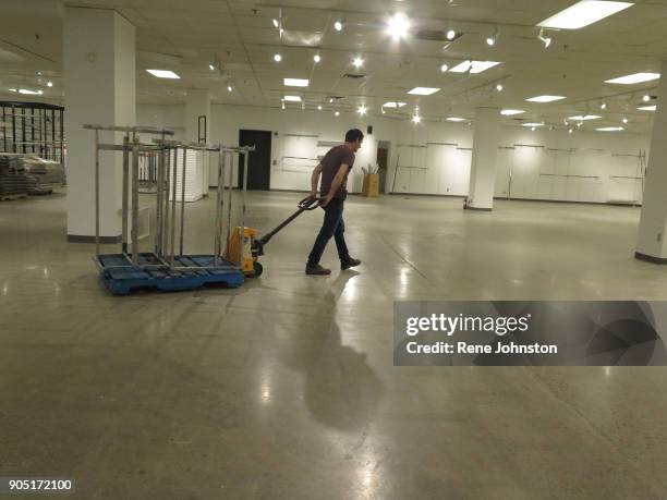 Sears Closing Final . A worker pulls away his lift with display frames. The Sears at Erin Mills Town Centre close out sales. It is one of the last 32...