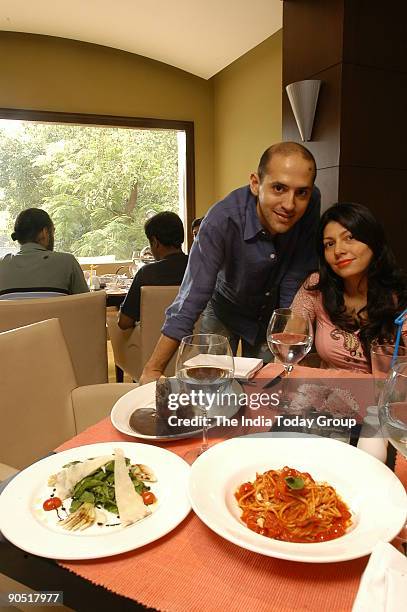 Andrea Pauro with his wife Pia, owner of Baci Restaurant at his Restaurant in Sunder Nagar market, New Delhi, India