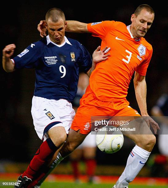 Kenny Miller of Scotland tackles Andre Ooijer of Netherlands during the FIFA 2010 World Cup Group 9 Qualifier match beteween Scotland and Netherlands...