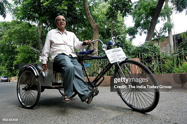 Professor Nirmal Deb, Jadavpur University Electrical dept , on a test ride inside the university campus on his hybrid Van Rickshaw in Kolkata, West...