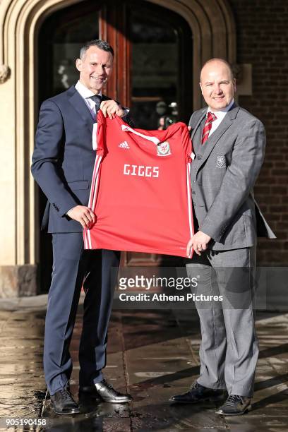 Ryan Giggs and Jonathan Ford, hold a Wales shirt after attending a press conference as he is announced as the new manager of Wales at Hensol Castle...