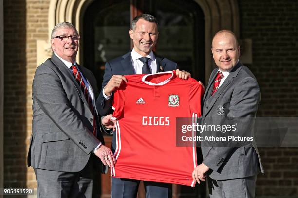 President David Griffiths, Ryan Giggs and Jonathan Ford, hold a Wales shirt after attending a press conference as he is announced as the new manager...