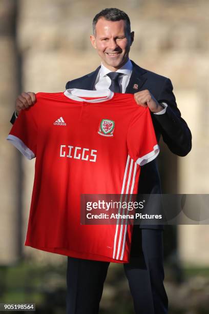 Ryan Giggs poses with a Welsh shirt after attending a press conference as he is announced as the new manager of Wales at Hensol Castle on January 15,...