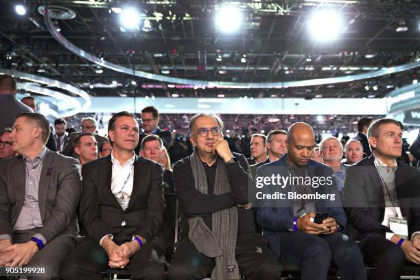 Sergio Marchionne, chief executive officer of Fiat Chrysler Automobiles NV , center, listens during the FCA press conference at the 2018 North...