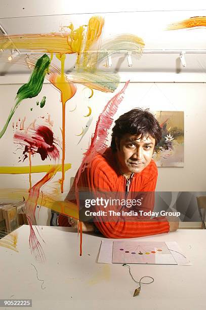 Painter Niladri Paul displays the process of colour therapy using a pendulum in New Delhi, India