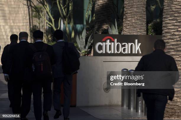 Pedestrians pass in front of a signage outside a Citigroup Inc. Bank branch in Los Angeles, California, U.S., on Thursday, Jan. 11, 2018. Citigroup...