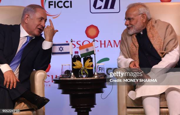 Indian Prime Minister Narendra Modi and Israeli Prime Minister Benjamin Netanyahu talk during the India-Israel Business Summit in New Delhi on...