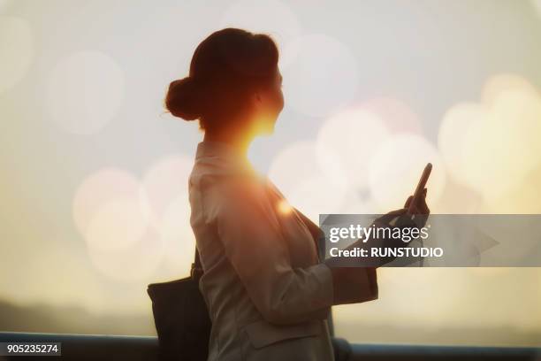 businesswoman using smartphone outdoors - wap foto e immagini stock