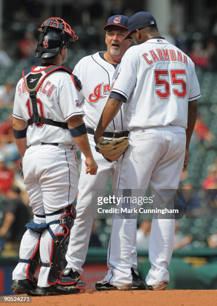 Pitching coach Carl Willis of the Cleveland Indians talks with Kelly Shoppach and Fausto Carmona in the first inning against the Texas Rangers during...