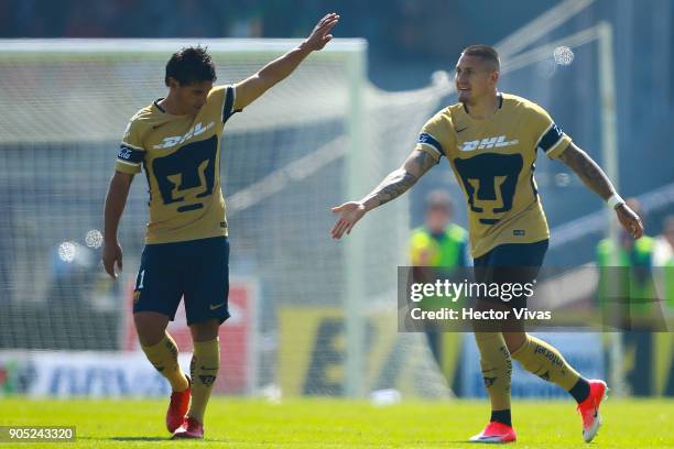 Nicolas Castillo of Pumas celebrates with teammate Matias Alustiza after scoring the first goal of his team during the second round match between...