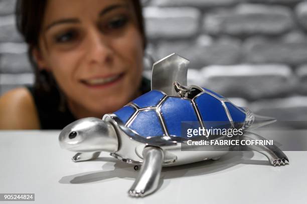 An automate representing a bird singing on the top of a tortoise is displayed at the stand of Swiss watch brand MB&F, on the opening day of the 28th...