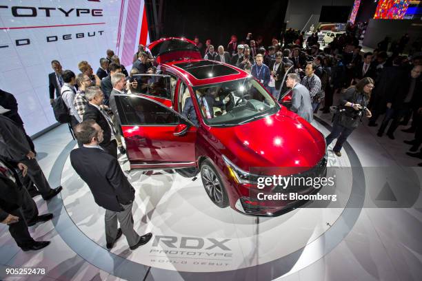 Members of the media view the Honda Motor Co. Acura RDX prototype crossover vehicle during the 2018 North American International Auto Show in...