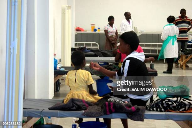 Patients affected by Cholera sit on beds at the Heroes stadium temporary transformed in a hospital on January 15, 2018 in Lusaka, Zambia. - Zambia...