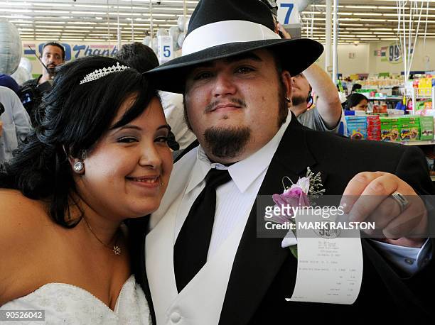 Lesley Barragan and John Tinker show their receipt after their 99 cent wedding ceremony at the 99 cent store in Los Angeles on September 9, 2009. The...