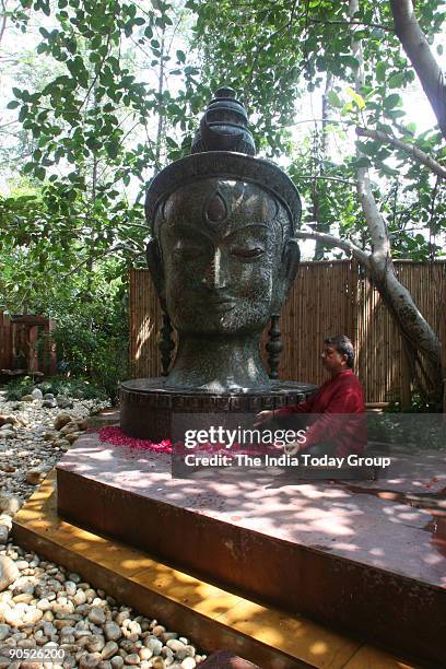 Satish Gupta, Painter sitting infront of Shiva Statue at his house in DLF Gurgaon, Haryana, India