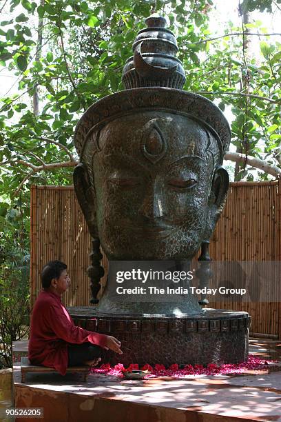 Satish Gupta, Painter sitting infront of Shiva Statue at his house in DLF Gurgaon, Haryana, India