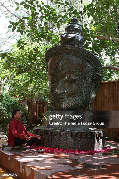 Satish Gupta, Painter sitting infront of Shiva Statue at his house in DLF Gurgaon, Haryana, India