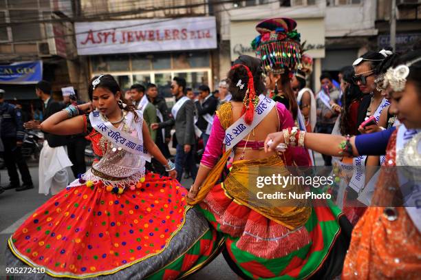 Nepalese Tharu community woman dance in a traditional attire during parade of the Maghi festival celebrations or the New Year of the Tharu community...