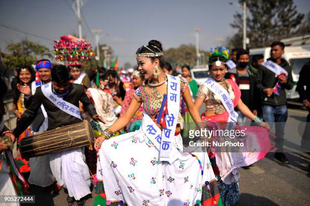 Nepalese Tharu community woman dance in a traditional attire during parade of the Maghi festival celebrations or the New Year of the Tharu community...
