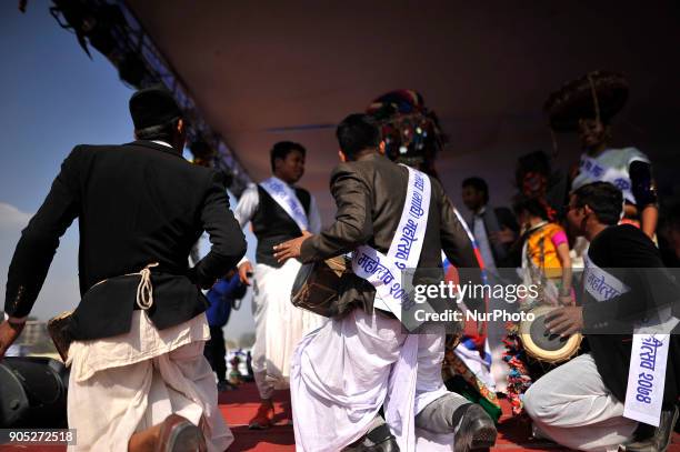 Nepalese Tharu community people plays traditional instruments during parade of the Maghi festival celebrations or the New Year of the Tharu community...