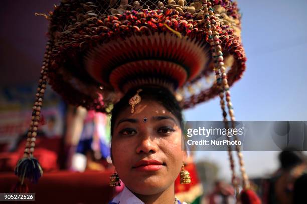 Portrait of Nepalese Tharu community girl in a traditional attire during prade of the Maghi festival celebrations or the New Year of the Tharu...