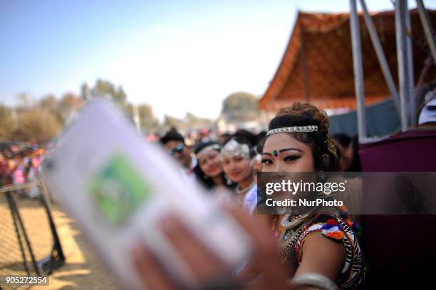 Nepalese Tharu community girls take selfie picture during parade of the Maghi festival celebrations or the New Year of the Tharu community at...