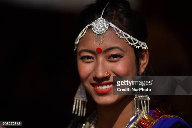 Smiling Portrait of Nepalese Tharu community girl in a traditional attire during prade of the Maghi festival celebrations or the New Year of the...
