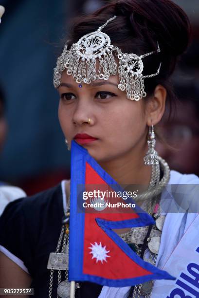 Portrait of Nepalese Tharu community girl in a traditional attire during prade of the Maghi festival celebrations or the New Year of the Tharu...