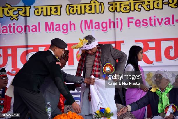 Nepalese Tharu community old man tighten traditional attire on Prime Minister Sher Bhadur Deuba during Maghi festival celebrations or the New Year of...