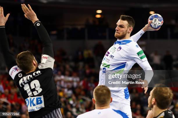 Borut Mackovsek of Slovenia is challenged by Hendrik Pekeler of Germany during the Men's Handball European Championship Group C match between...