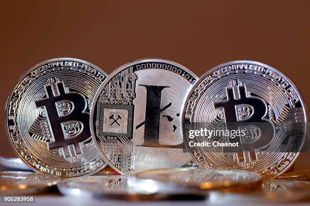 In this photo illustration, a visual representation of digital cryptocurrencies, Bitcoin and Litecoin are displayed on January 15, 2018 in Paris,...