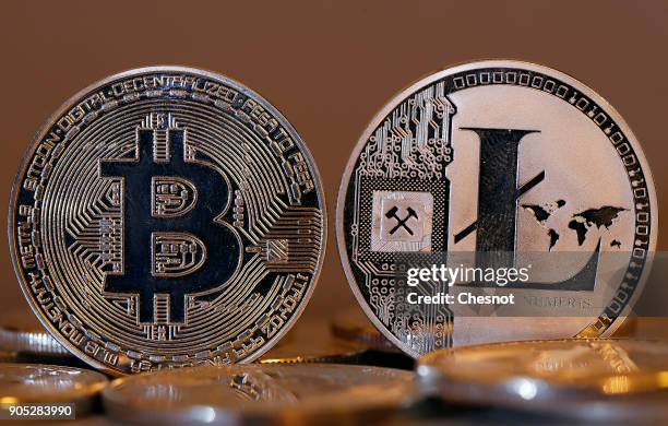 In this photo illustration, a visual representation of digital cryptocurrencies, Bitcoin and Litecoin are displayed on January 15, 2018 in Paris,...