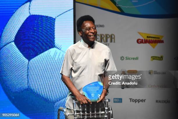Edson Arantes do Nascimento, known in the World by the nickname of Pele, uses a walker to stand on stage, during the opening event of the 2018...