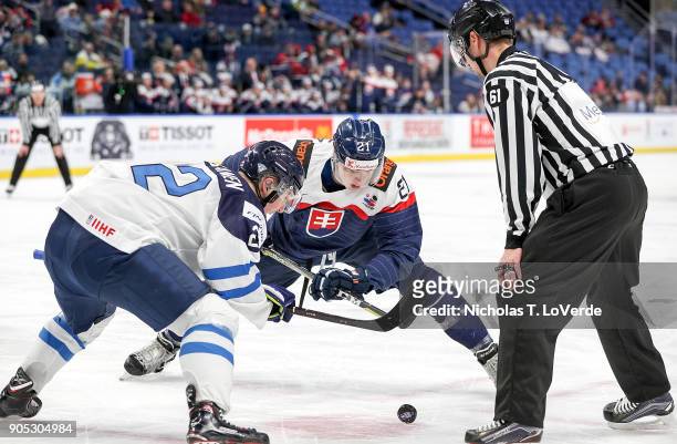 Adam Ruzicka of Slovakia battles for a face-off win against Aapeli Räsänen of Finland during the first period of play in the IIHF World Junior...