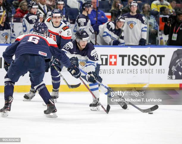 Eeli Tolvanen of Finland passes the puck with Martin Fehérváry of Slovakia applying pressure during the second period of play in the IIHF World...