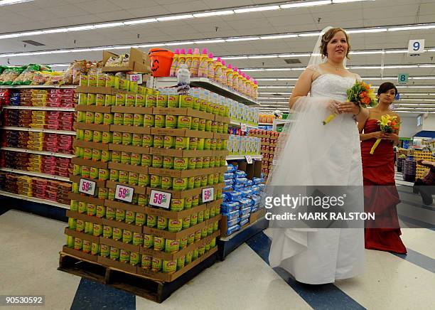 Brides wait for their 99 cent wedding ceremony at the 99 cent store in Los Angeles on September 9, 2009. The budget supermarket chain helped nine...