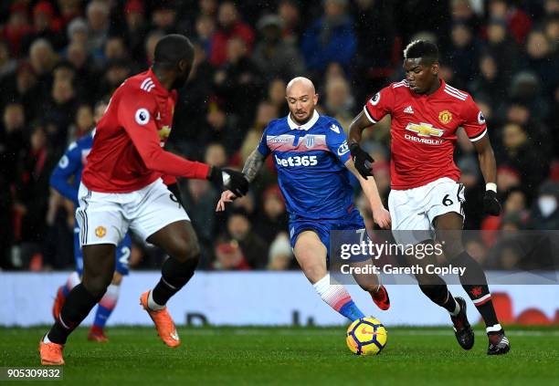 Stephen Ireland of Stoke City and Paul Pogba of Manchester United battle for the ball during the Premier League match between Manchester United and...