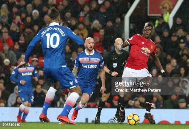 Paul Pogba of Manchester United in action with Maxim Choupo-Moting of Stoke City during the Premier League match between Manchester United and Stoke...