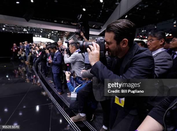 Photographers take pictures of the new Infiniti Q Inspiration concept vehicle as it makes its debut at the 2018 North American International Auto...