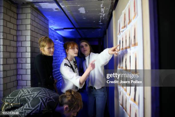 Models look at the model board ahead of the Dawid Tomaszewski show during the MBFW January 2018 at ewerk on January 15, 2018 in Berlin, Germany.