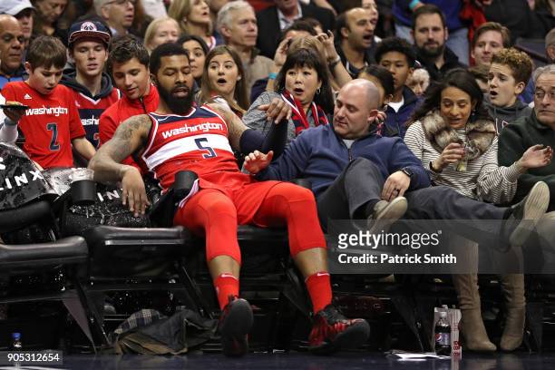 Markieff Morris of the Washington Wizards crashes into the stands against the Milwaukee Bucks during the first half at Capital One Arena on January...