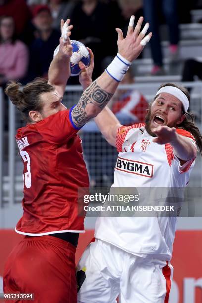 Denmark's Mikkel Hansen scores a goal against Czech Republic's Pavel Horak during the group D handball match of the Men's 2018 EHF European Handball...