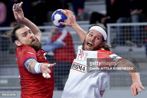 Denmark's Mikkel Hansen scores a goal against Czech Republic's Pavel Horak during the group D handball match of the Men's 2018 EHF European Handball...
