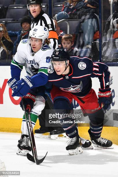 Markus Granlund of the Vancouver Canucks and Matt Calvert of the Columbus Blue Jackets battle for position on January 12, 2018 at Nationwide Arena in...