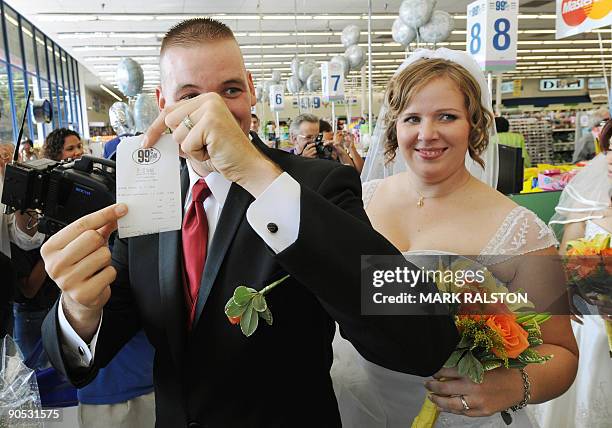 Whillis Hall and Emily Wiley show their receipt for their 99 cent wedding ceremony at a checkout at the 99 cent store in Los Angeles on September 9,...