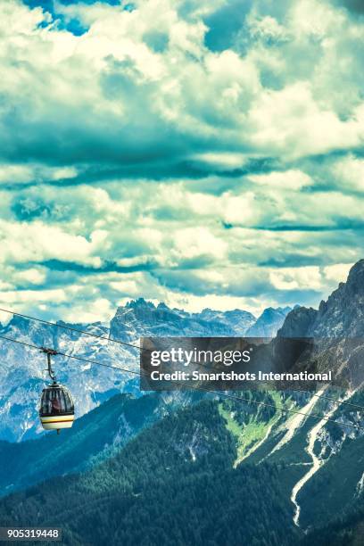 aerial alpine image with cable car and a majestic landscape background in south tyrol, italy - aerial cable stock pictures, royalty-free photos & images