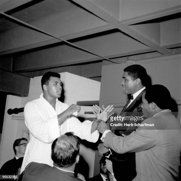 World Heavyweight Title: Muhammad Ali arguing wtih next opponent Ernie Terrell in locker room after fight vs Cleveland Williams at Astrodome....